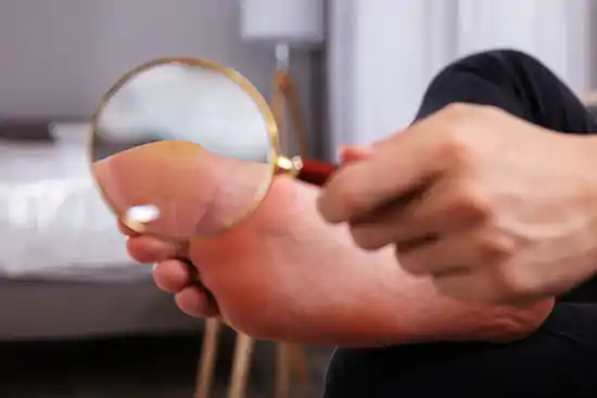 magnifier pointing to bare feet