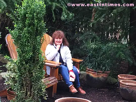 Dr. Gwen Ford relaxing on bench in Savage Garden, Knoxville, Tennessee