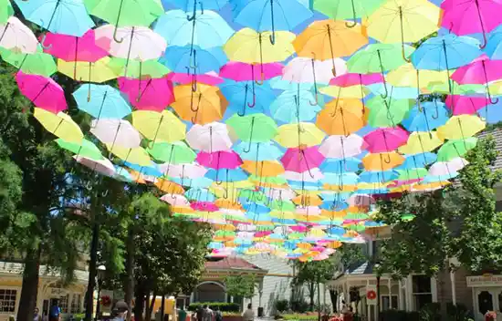 Dollywood Flower Food Festival colorful umbrellas are suspended above Showstreet 