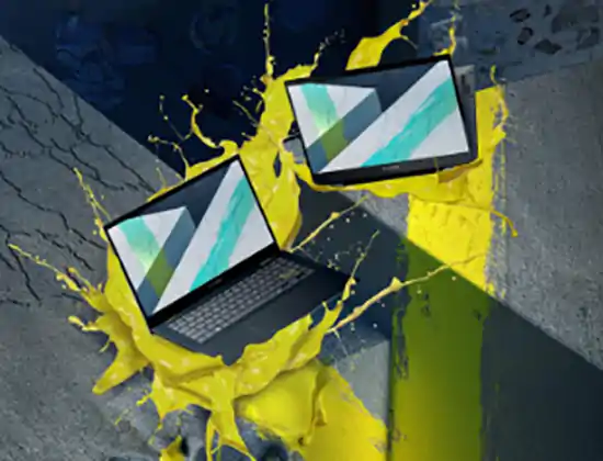 2 laptop computers in yellow paint splash