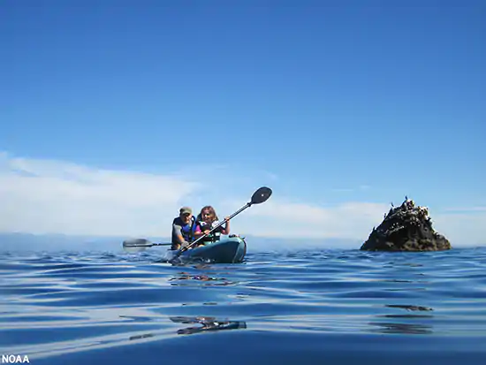 A father and daughter enjoy a kayak trip in Channel Islands National Marine Sanctuary in California 