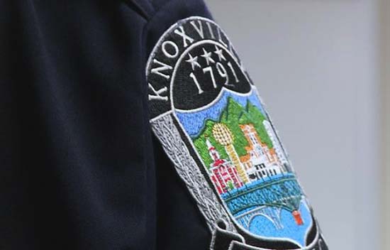 Hand with knoxville police patch