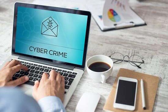 laptop with cyber crime on screen